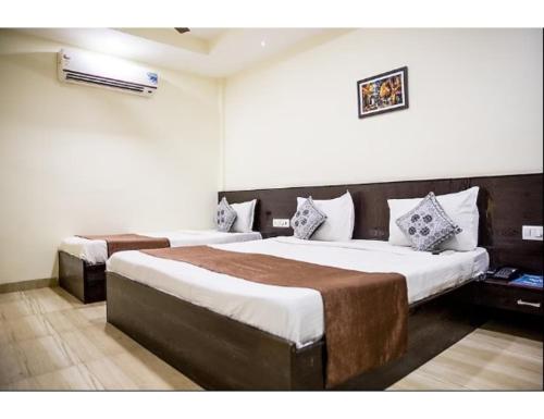 a bedroom with two beds in a room at Hotel Wardhman, Jabalpur in Jabalpur