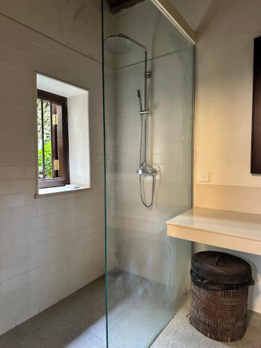 a shower with a glass door in a bathroom at 89 Leyn Baan by AQUA Villa in Galle