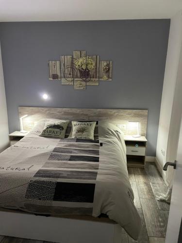 a bedroom with a large bed with two pillows at Casita tranquila in Talavera de la Reina