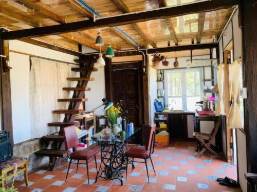 a room with a table and chairs and a wooden ceiling at Romantic house on a pine hill Dalat in Xuan An
