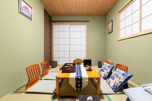 a dining room with a table and two chairs at 大阪指定特区民泊小田別荘なんば店OdaVillaNamba in Osaka
