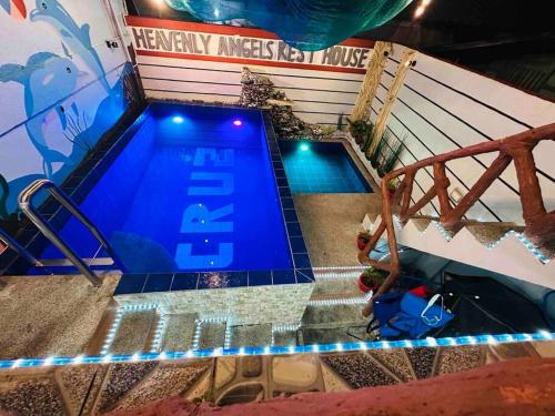 an overhead view of a swimming pool with blue lights at affordable 2 bedroom rest house w/ pools & parking in Santa Rosa