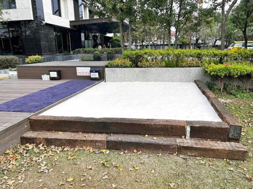 a large white mattress in front of a building at Hsin Hotel in Chiayi City