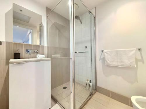 a bathroom with a glass shower with a sink at Charming 1BR Southbank w balcony & free parking#TI22 in Melbourne