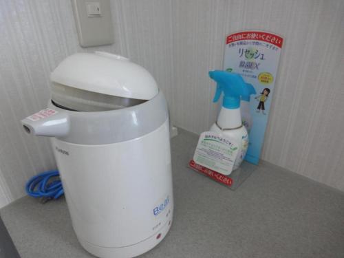 a white mixer sitting next to a bottle of cleaner at Tottori City Hotel / Vacation STAY 81359 in Tottori