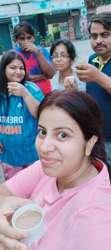 a woman sitting down with a cup of coffee at Darsh Bungalow....Amol Pade in Neral