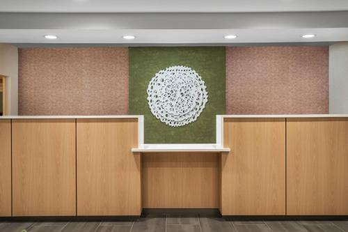 a lobby with wooden cabinets and a painting on the wall at Fairfield Inn & Suites by Marriott Chattanooga South East Ridge in Chattanooga