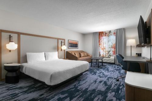 a hotel room with a bed and a couch at Fairfield Inn & Suites by Marriott Chattanooga South East Ridge in Chattanooga
