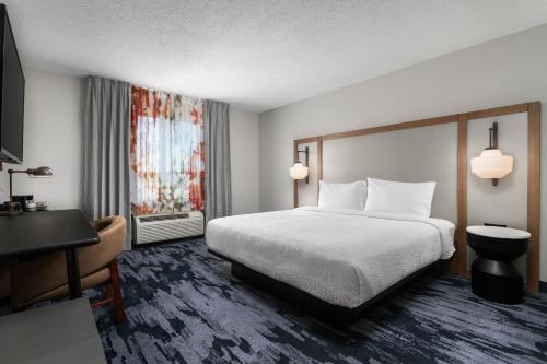 a hotel room with a bed and a desk at Fairfield Inn & Suites by Marriott Chattanooga South East Ridge in Chattanooga