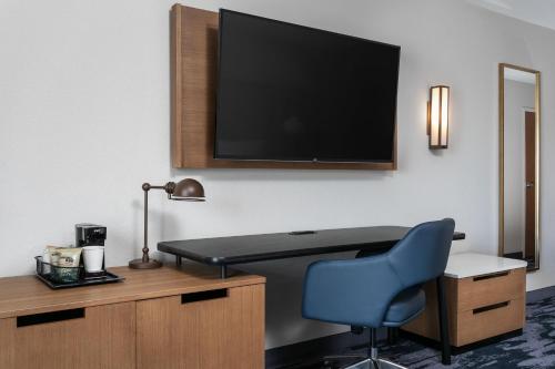 a room with a desk and a tv and a chair at Fairfield Inn & Suites by Marriott Chattanooga South East Ridge in Chattanooga