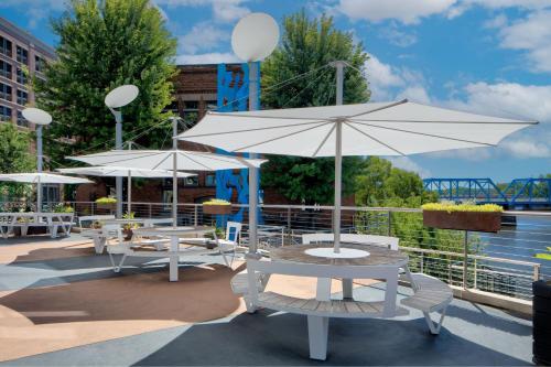a group of tables and umbrellas on a patio at JW Marriott Grand Rapids in Grand Rapids