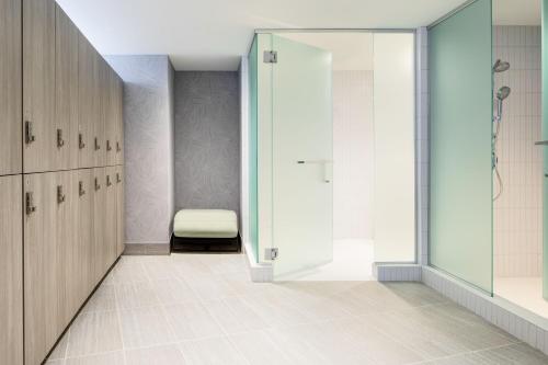a bathroom with a shower and a bench at JW Marriott Grand Rapids in Grand Rapids