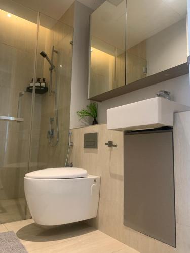 a bathroom with a white toilet and a shower at 3 Bedroom Condominium in LUMI TROPICANA in Petaling Jaya