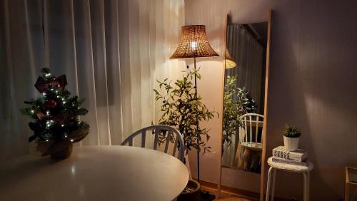a room with a table with a christmas tree and a lamp at New Corestay # Edae Stn 2min 2R 2F # near Hongdae in Seoul