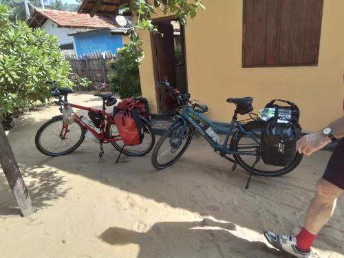 two bikes parked in front of a house at Dolphin Village in Kalpitiya