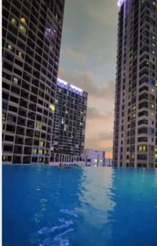 a view of two tall buildings and a swimming pool at I SOHO I-CITY SHAH ALAM in Shah Alam