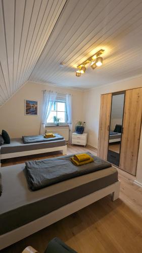 two beds in a room with a ceiling at Ferienhaus Dhrontal in Neumagen-Dhron