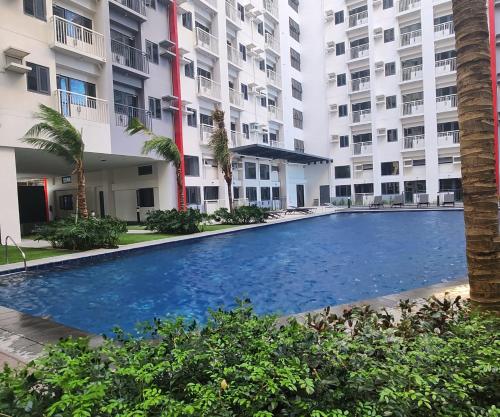 an empty swimming pool in front of a building at Bloom Residences Condo 2Br in Manila