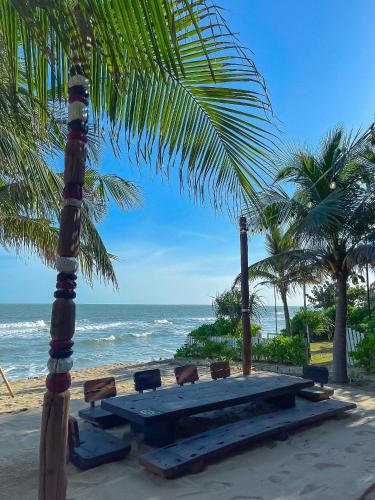 a picnic table on the beach next to the ocean at Long Hải Channel Beach Resort in Long Hai