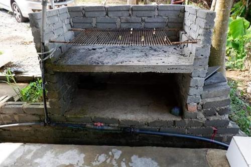 a brick oven with a hose coming out of it at Chu Mon's Homestay Janda Baik (15 min from river) in Bentong