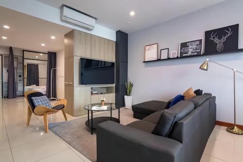 a living room with a couch and a tv at Sunrise @ Gurney in George Town