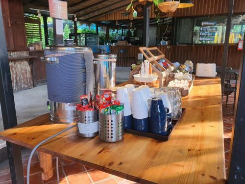 a wooden table with food on top of it at บ้านนกฮูกอิงไม้ ริมเล in Ban Khlong Sai