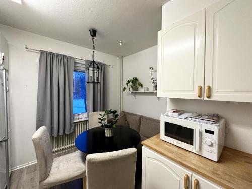 a small kitchen with a table and a microwave at Nice apartment in Motala in Motala