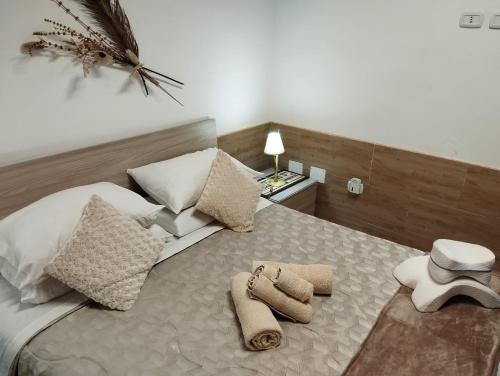 a bedroom with a bed with towels on it at Affittacamere Vicino al Porto in Porto Torres