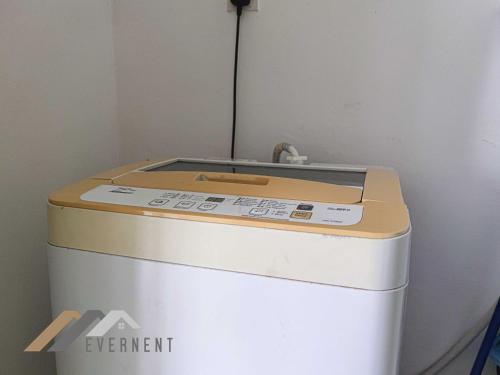 a washing machine sitting on top of a room at Marina Times Square Homestay by Evernent in Miri