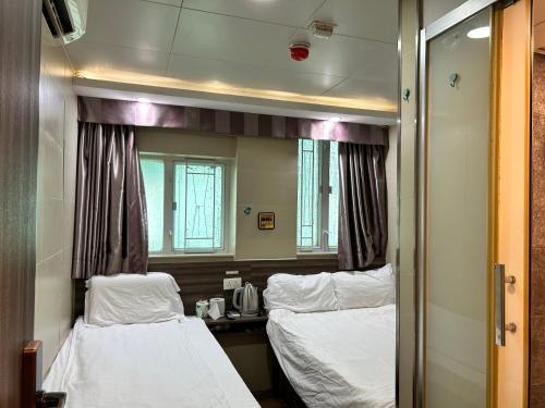 a hospital room with two beds and a mirror at 香港星星旅馆 b&b in Hong Kong