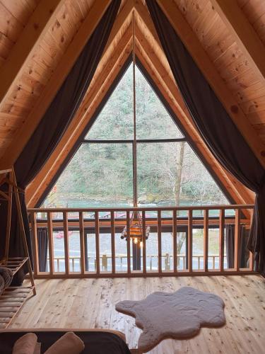 a room with a large window in a tent at Golden Rose Bungalov in Ardeşen