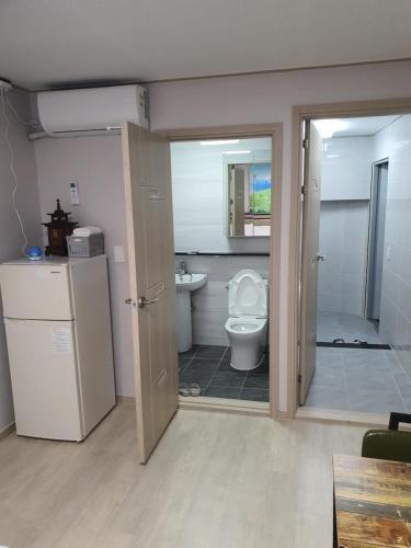 a bathroom with a toilet and a sink at Ara Guesthouse in Busan