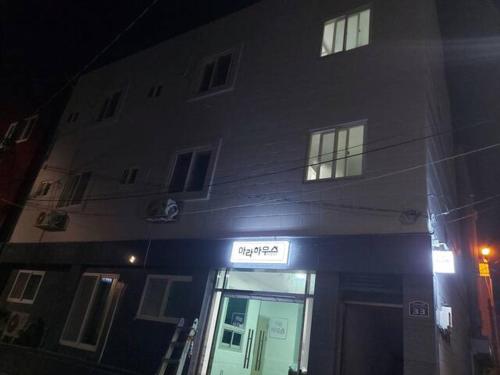 a building with a sign in front of it at Ara Guesthouse in Busan