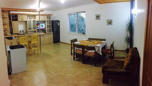 a kitchen and dining room with a table and chairs at Slagora Apartment in Yaremche