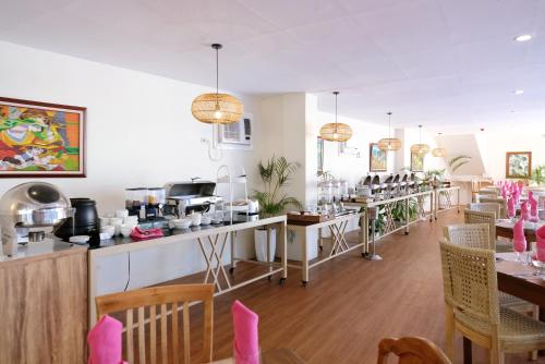 a restaurant with a bar with tables and chairs at Sierra Hotel in Dumaguete