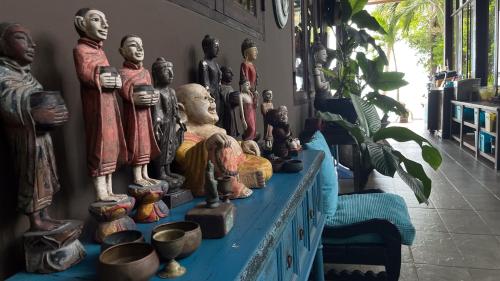 a group of statues on a table in a room at Private Beach House @ Hin Kong Beach in Hinkong