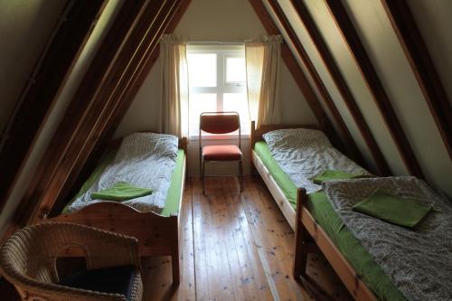 a small room with two beds and a window at Hömluholt Holiday Homes in Hömluholt