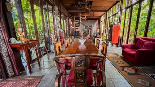 a dining room with a table and chairs in a train at Private Beach House @ Hin Kong Beach in Hinkong