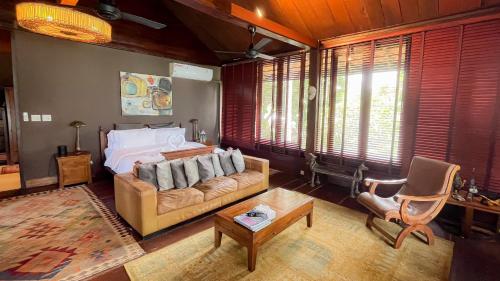 a living room with a couch and a bed at Private Beach House @ Hin Kong Beach in Hinkong