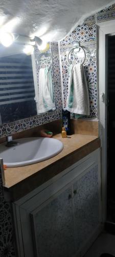 a bathroom with a sink and a mirror at L'Oa in Rabat