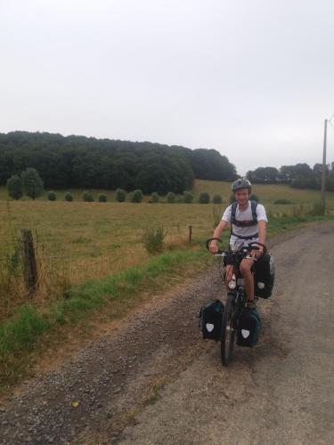 a person riding a bike down a dirt road at Gite de Baive in Assesse