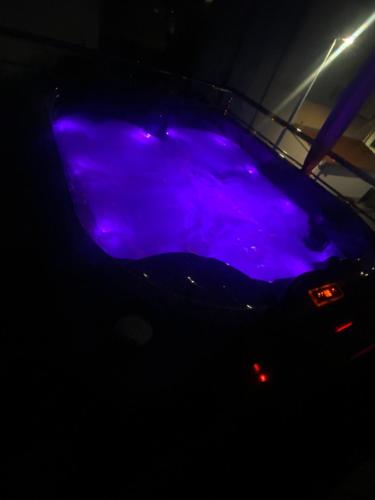 a blue light on the front of a car at night at Luxury apartment with jacuzzi in Podstrana