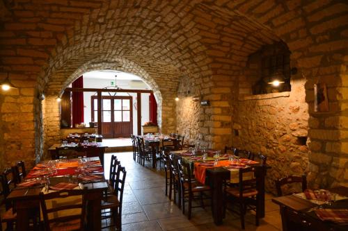 a dining room with tables and chairs in a building at Agriturismo Biorussi in Carpino