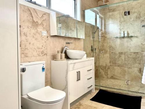 a bathroom with a toilet and a sink and a shower at Luxury stay in Williamstown in Williamstown