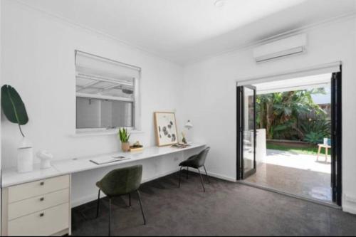 an office with a desk and two chairs and a window at Luxury stay in Williamstown in Williamstown