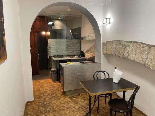 a kitchen with a table and a table and chairs at Prahabel - K10 in Prague