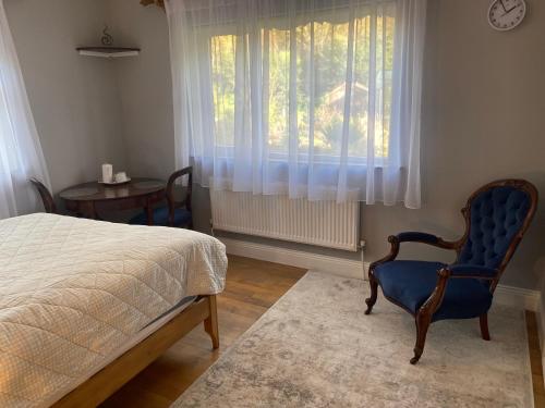 a bedroom with a bed and a chair and a window at Victoria's house in Kells