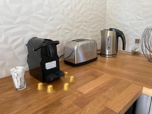 a counter top with a coffee maker and a toaster at Villa proche d'Avignon. in Le Pontet