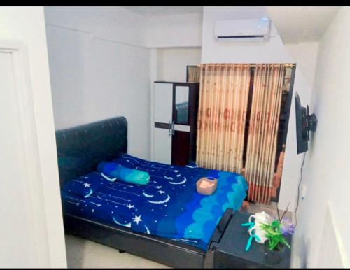 a small bedroom with a blue bed in a room at Sleepwell in Tambun-lobangbuaja