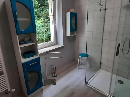 a bathroom with a glass shower and a stool at Property in Burgk in Burgk